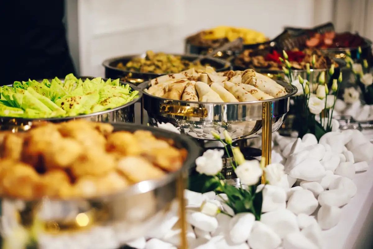 Buffet station with wraps and salad in silver chafing dishes, available in Elmhurst and Sunnyside, Queens.
